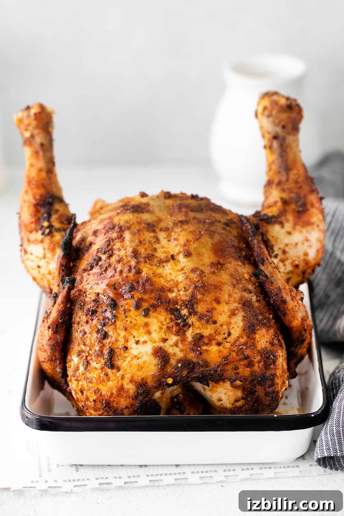 Juicy Beer Can Chicken Recipe with Crispy Skin 3 beer can chicken sitting in white pan.