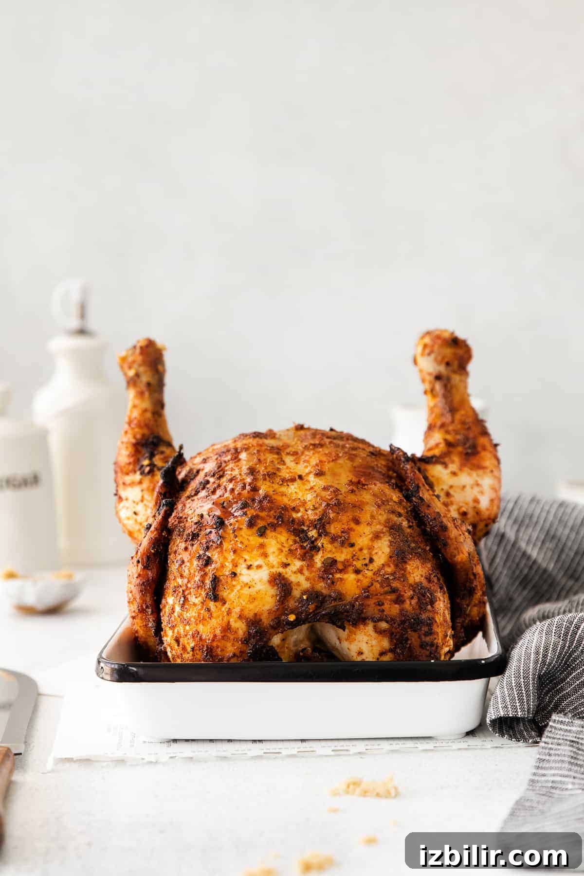 Juicy Beer Can Chicken Recipe with Crispy Skin 8 whole chicken in pan.