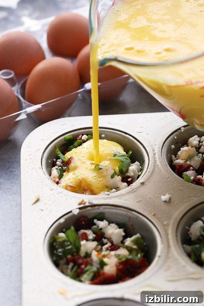 pouring eggs into muffin tin