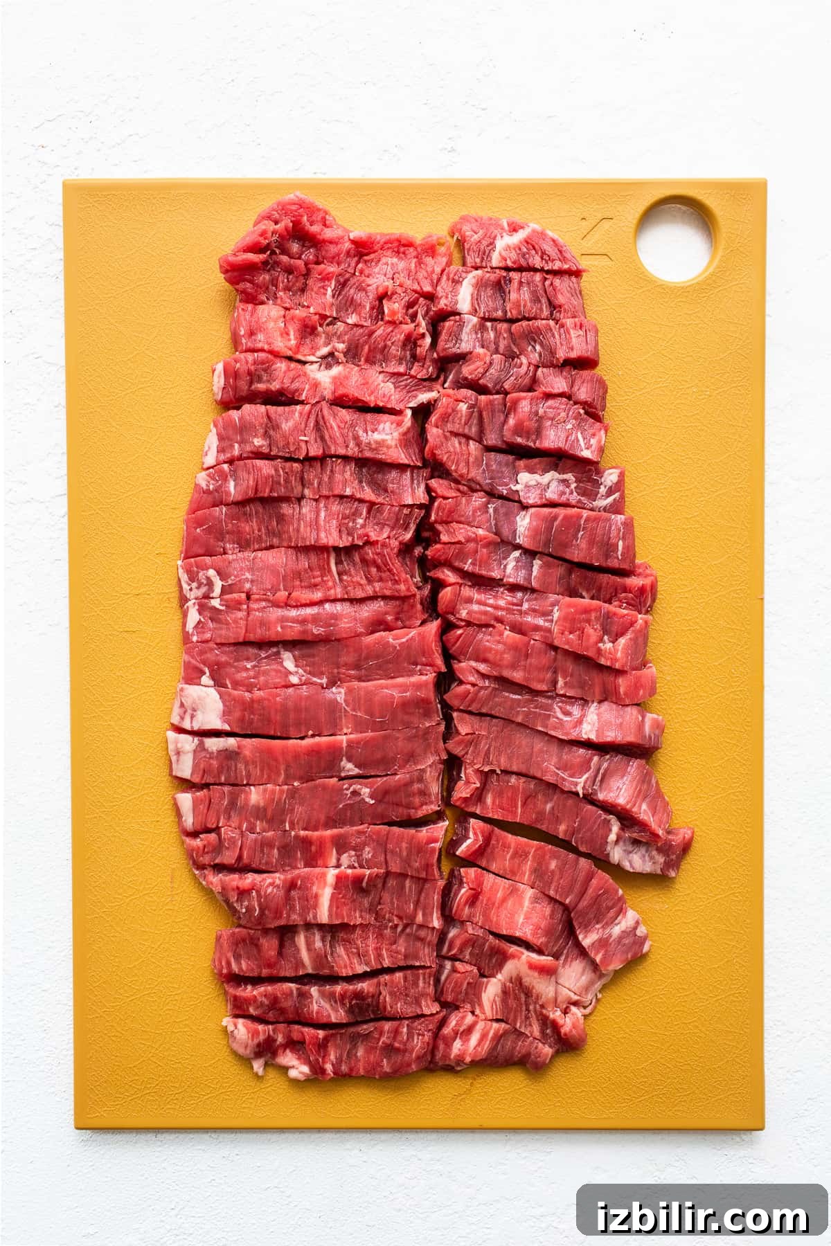 Sliced flank steak sliced flank steak on cutting board.