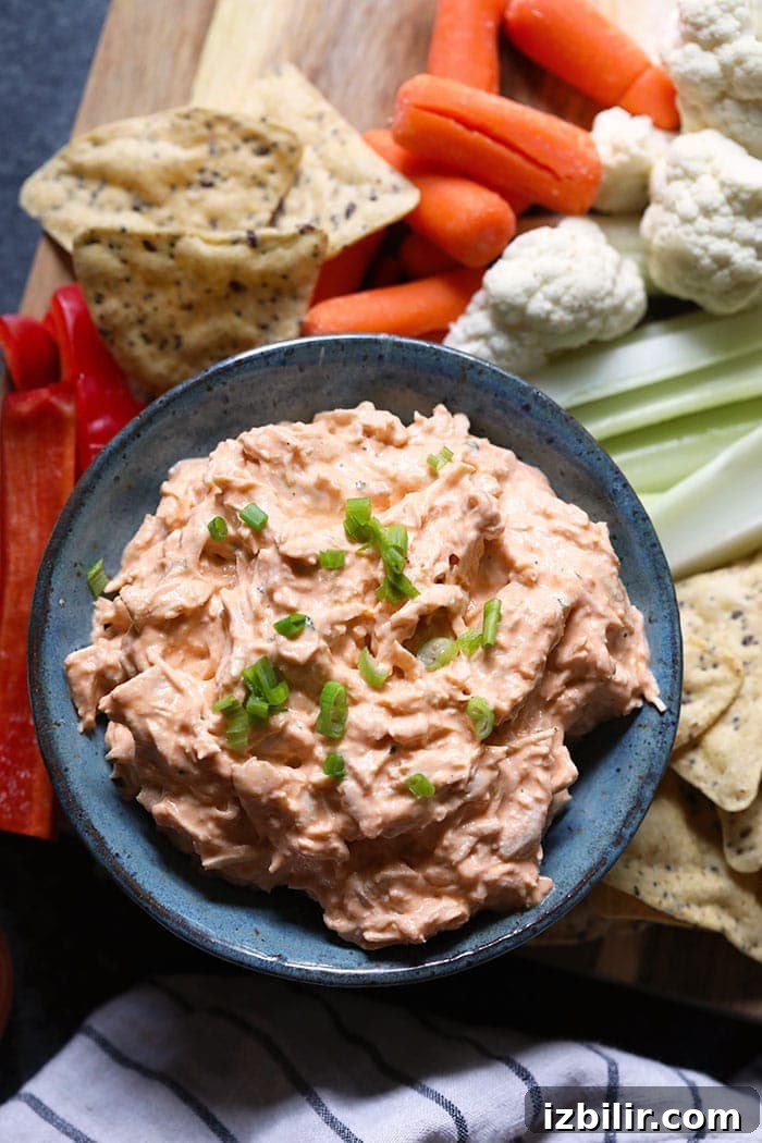 A bowl of buffalo chicken dip with fixings A bowl of buffalo chicken dip with fixings
