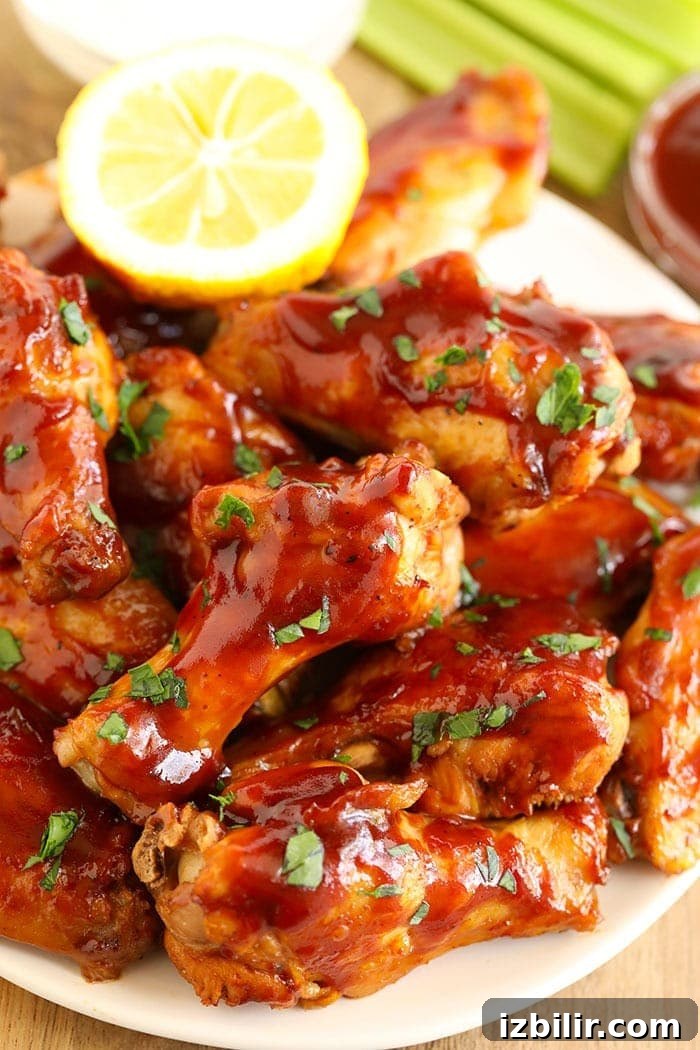 BBQ wings plated with lemon garnish bbq wings on a plate with lemon
