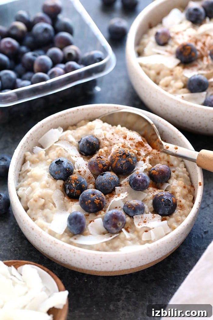 Creamy Coconut Slow Cooker Steel Cut Oats Bowl of creamy coconut slow cooker steel cut oats with spoon