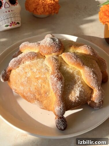 Pan de Muerto loaves on a baking sheet
