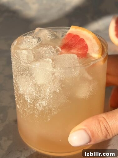 Paloma Mocktail in a salt-rimmed glass with grapefruit garnish
