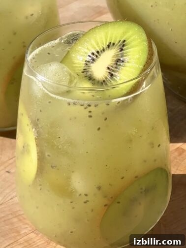 Pitcher of kiwi agua fresca with sliced kiwi garnish