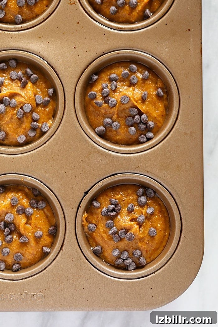 Gluten free pumpkin muffin batter in a pan