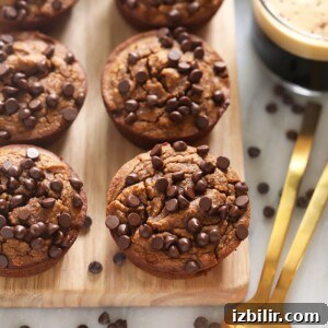 Gluten-free chocolate chip muffins on a wooden cutting board.
