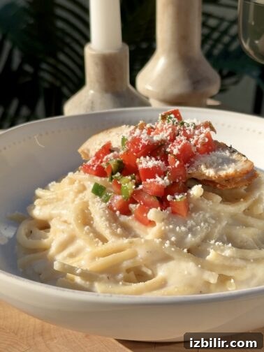 Spaghetti Blanco topped with pollo asado and pico de gallo