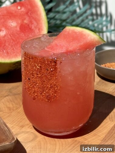Watermelon Margarita in a glass with a chamoy-Tajín rim