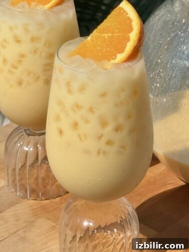 Glass pitcher of Morir Soñando with ice and orange slices