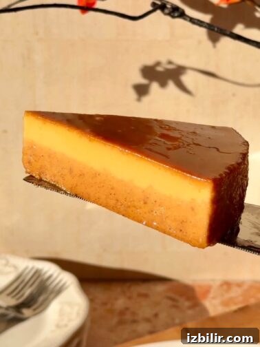 Pumpkin Spice Flan on a plate, drizzled with caramel