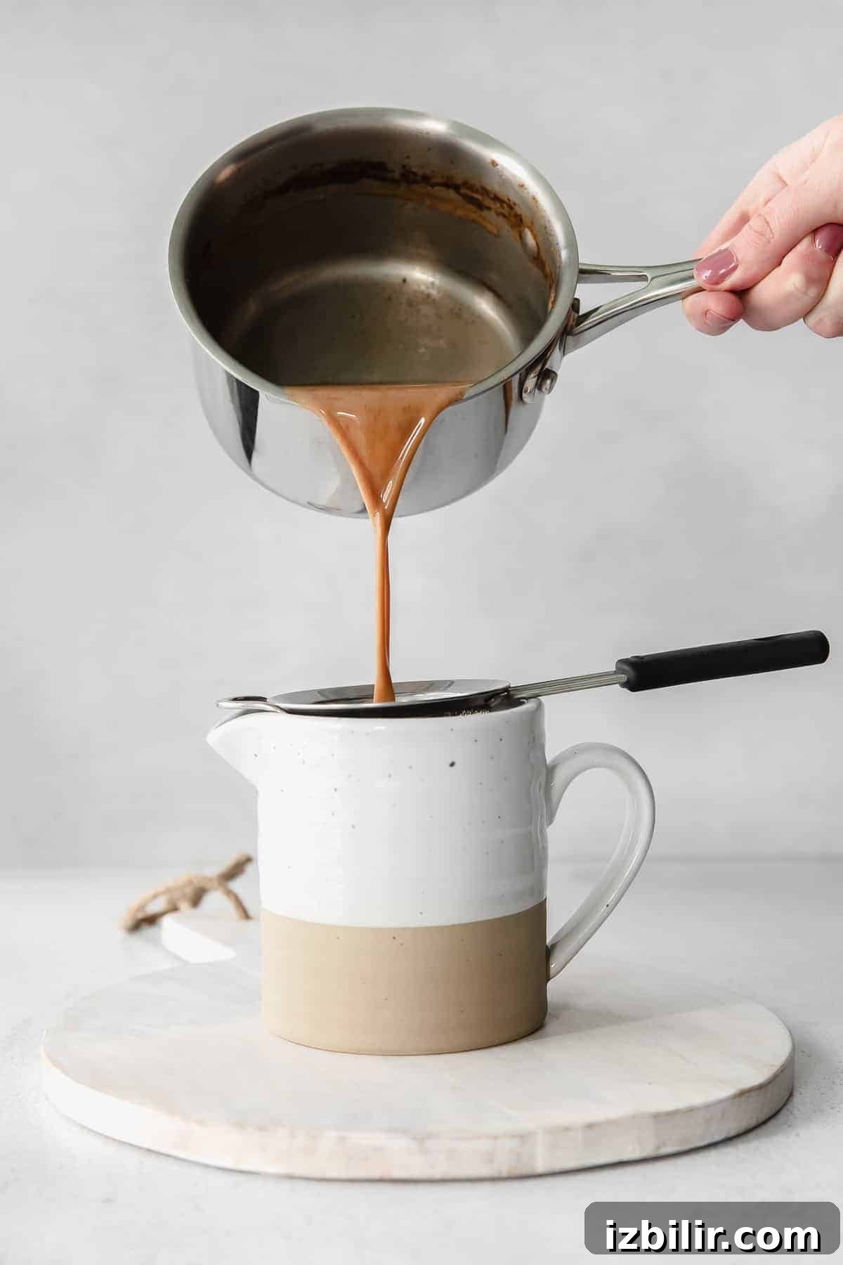 sieving chai tea 