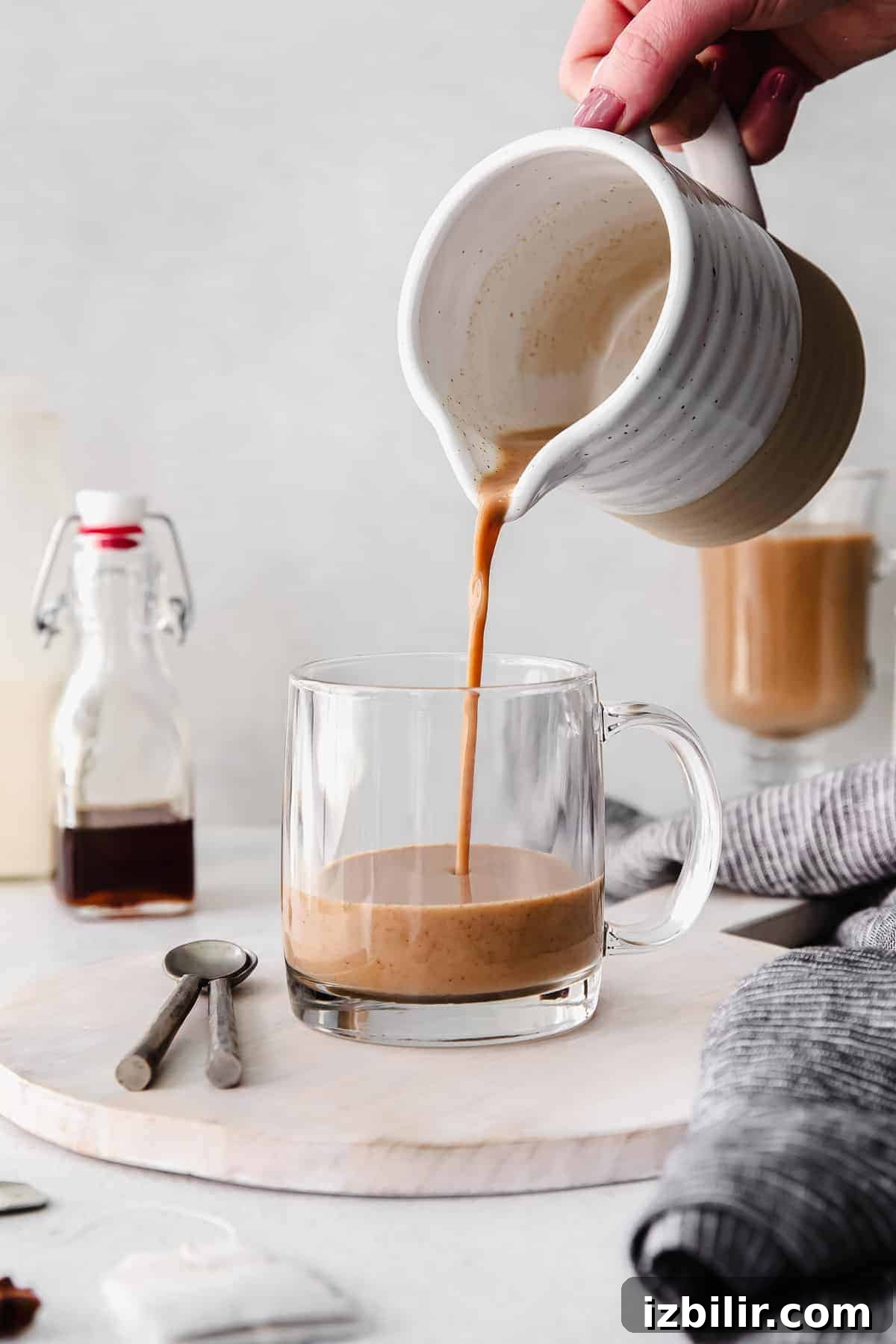 pouring chai tea into mug