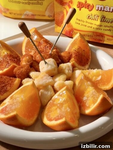 Spicy and sour mango orange jello shots in orange halves
