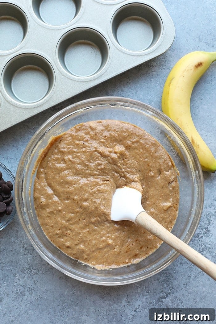 Banana chocolate chip muffin batter in a bowl. Banana chocolate chip muffin batter in a bowl.