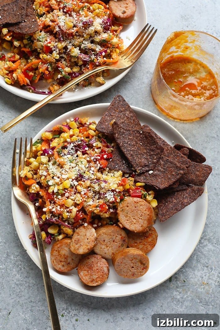 Thai Chili Corn Salad served as a side dish. Corn salad with a side of sausage and chips