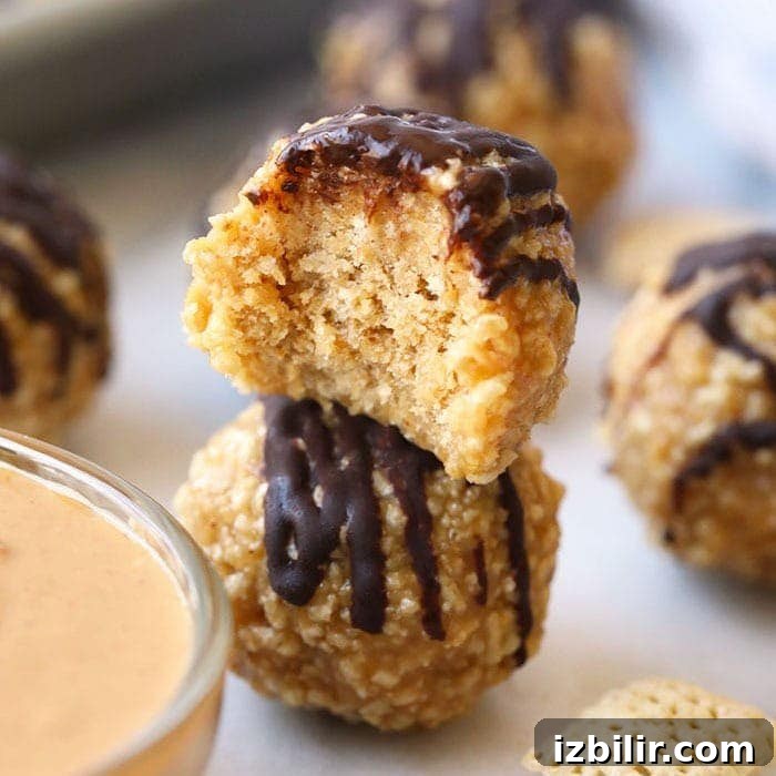 No-Bake Peanut Butter Honey Chex Cereal Balls 2 A bowl of granola bites with a scoop of peanut butter dipping sauce.