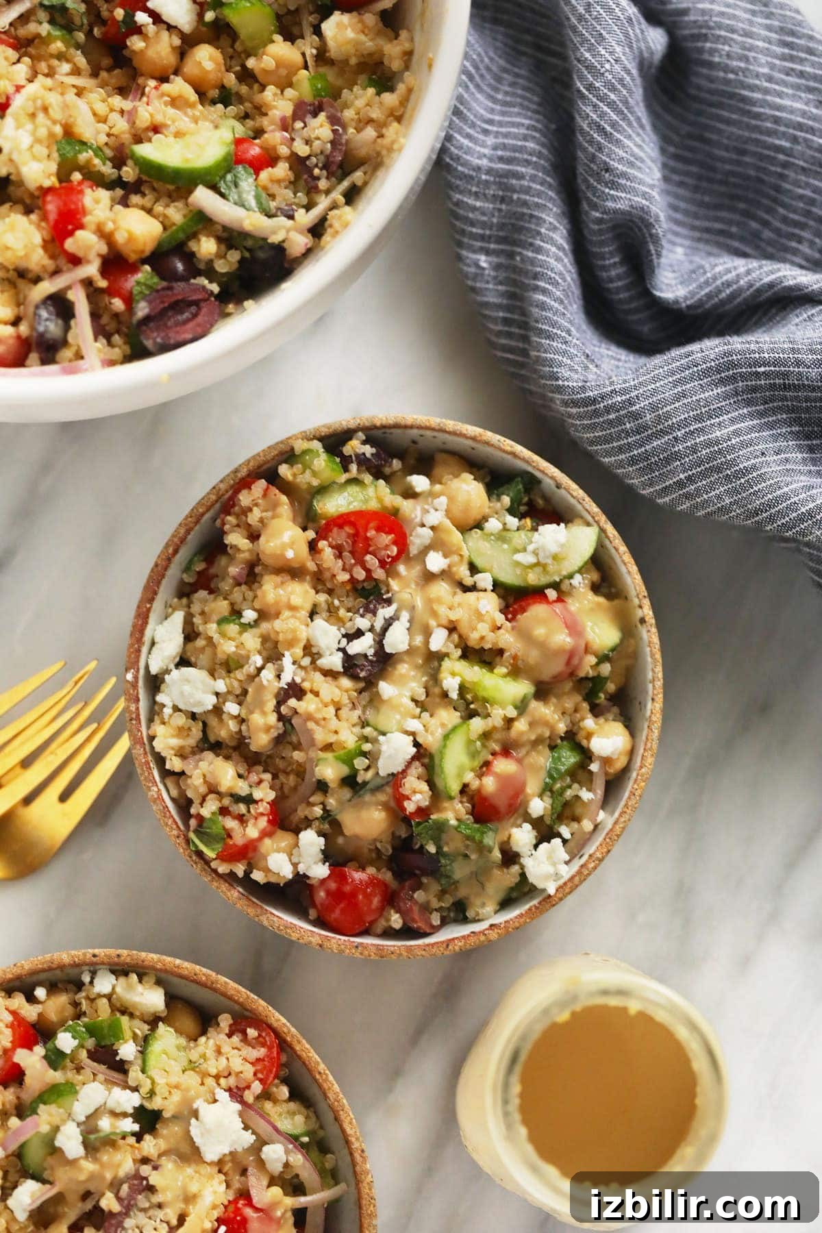 2 bowls of quinoa salad with dressing.