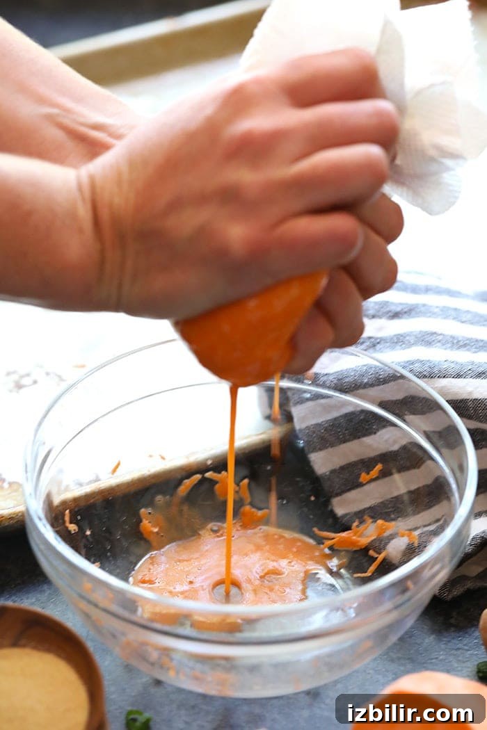 Grate sweet potatoes and make these baked sweet potato tater tots Squeezing liquid out of grated sweet potatoes.