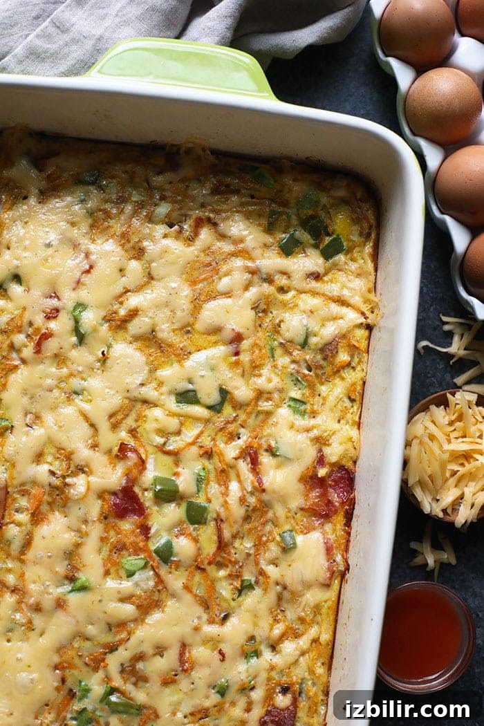 Finished breakfast casserole with cheese sprinkled over the top