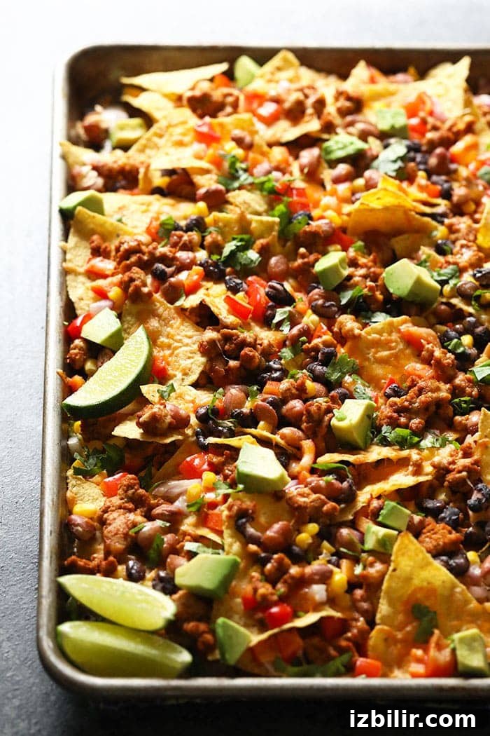 Chicken nachos on baking sheet.