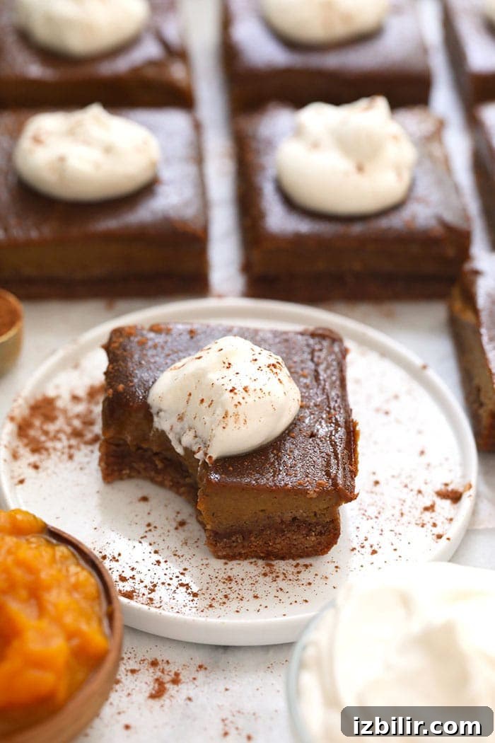 These pumpkin pie bars are the perfect healthy dessert for any fall occasion! A pumpkin pie bar on a plate