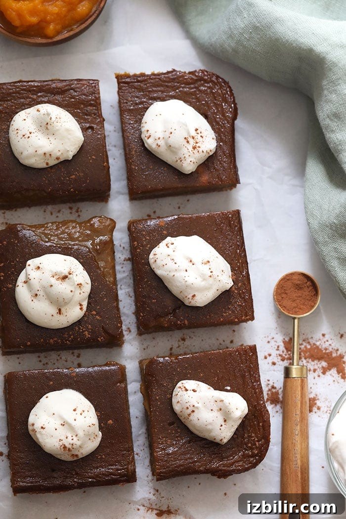 Pumpkin pie bars plated Pumpkin pie bars with whipped cream topping