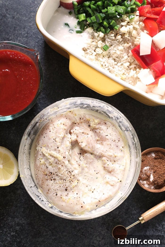 Chicken marinating in Greek yogurt chicken marinating in a bowl