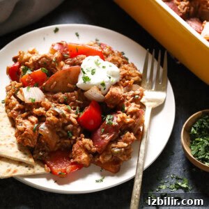 Served chicken tikka masala casserole An easy chicken casserole with meat and vegetables on a white plate.