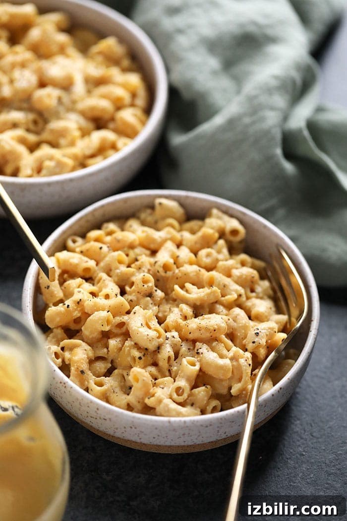 Get ready for the best vegan mac and cheese you've ever had! It's made with a cashew cream sauce that is easy to make and oh so delicious. vegan mac and cheese in a bowl