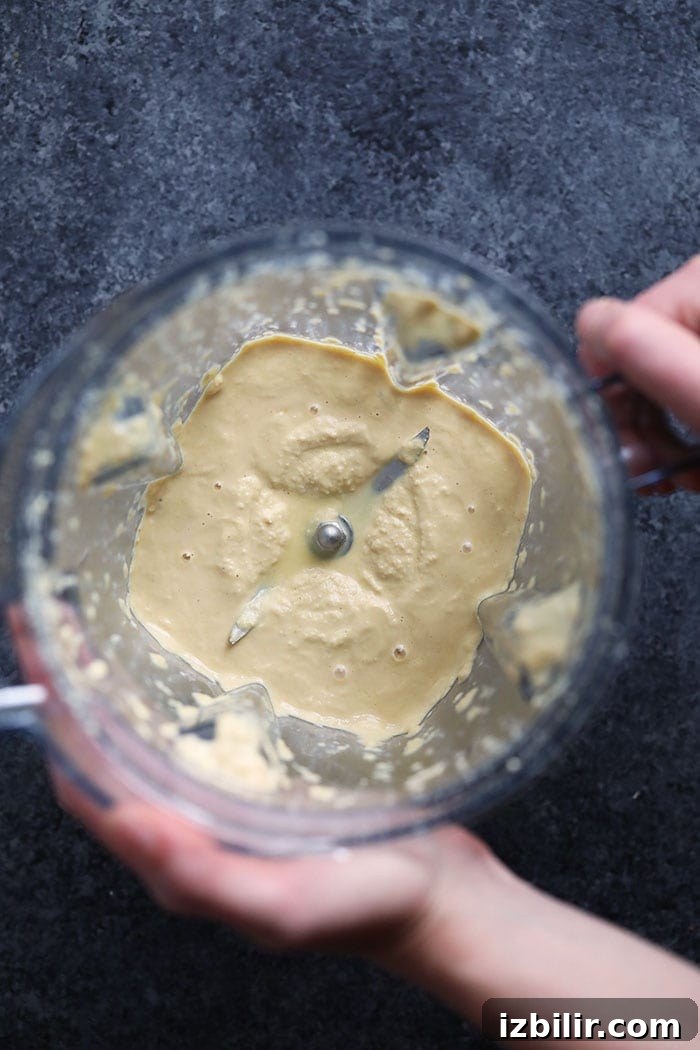 Cashew cream sauce in a blender. a blender with cashew cream sauce in it