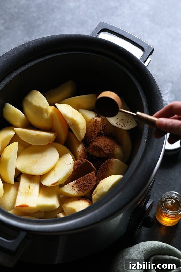 Sliced apples in the crockpot Sliced apples in a crockpot