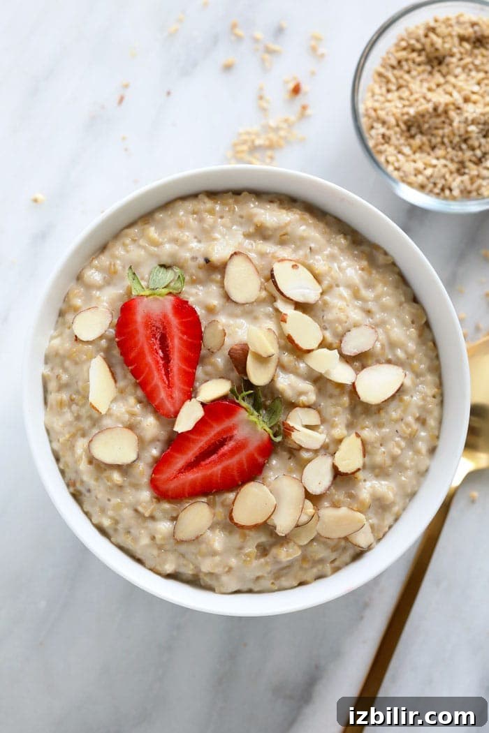 Stovetop Steel Cut Oats are packed with fiber, protein, and complex carbs Bowl of steel cut oats topped with strawberries and almonds