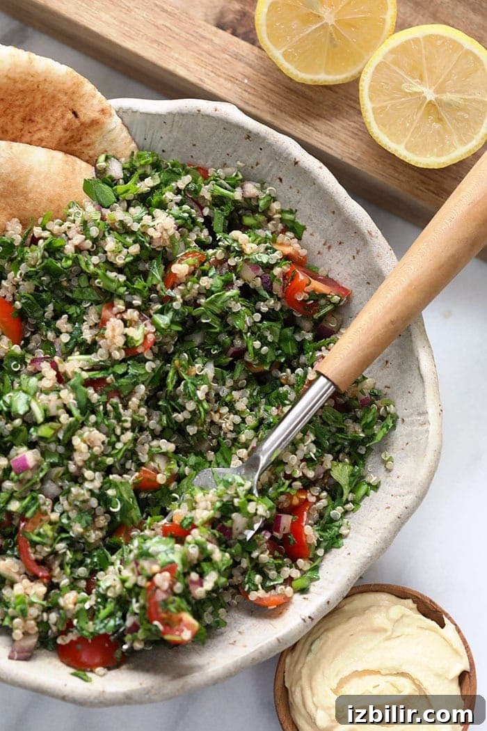 Quinoa Tabbouleh Recipe: Fresh Mediterranean Salad 5 Taking a bite of a quinoa tabouli.