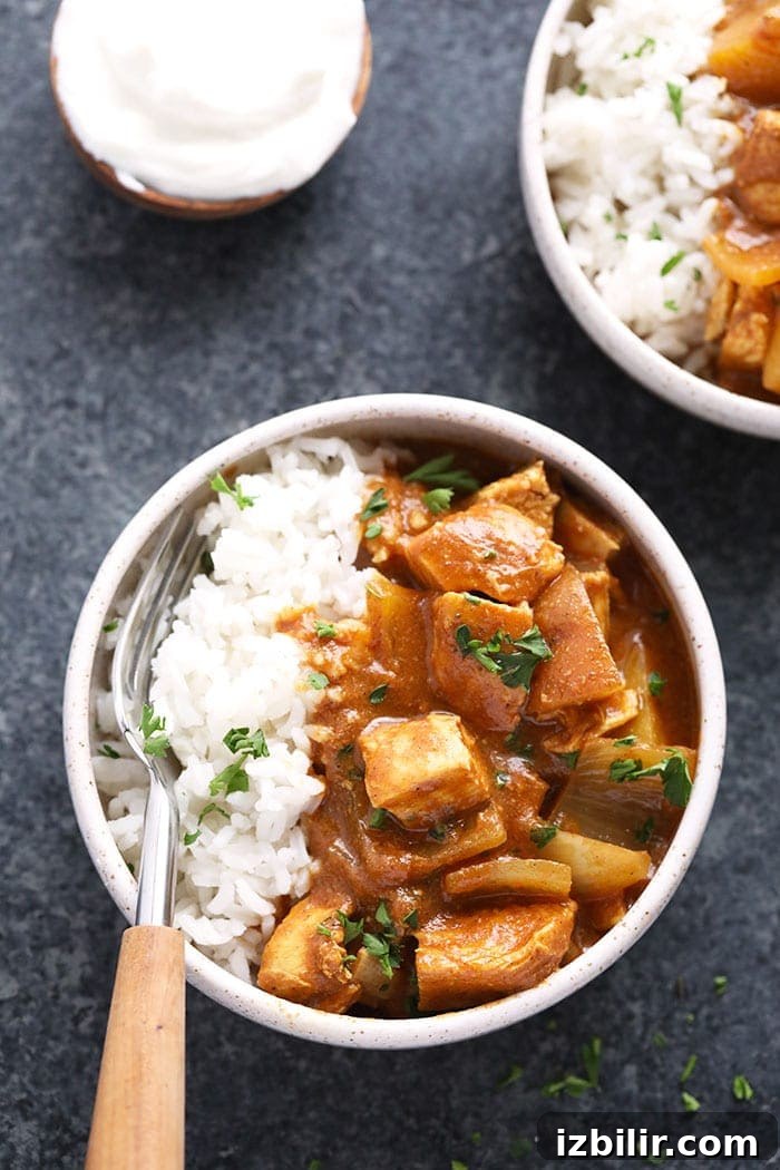 slow cooker healthy chicken tikka masala in a bowl with rice