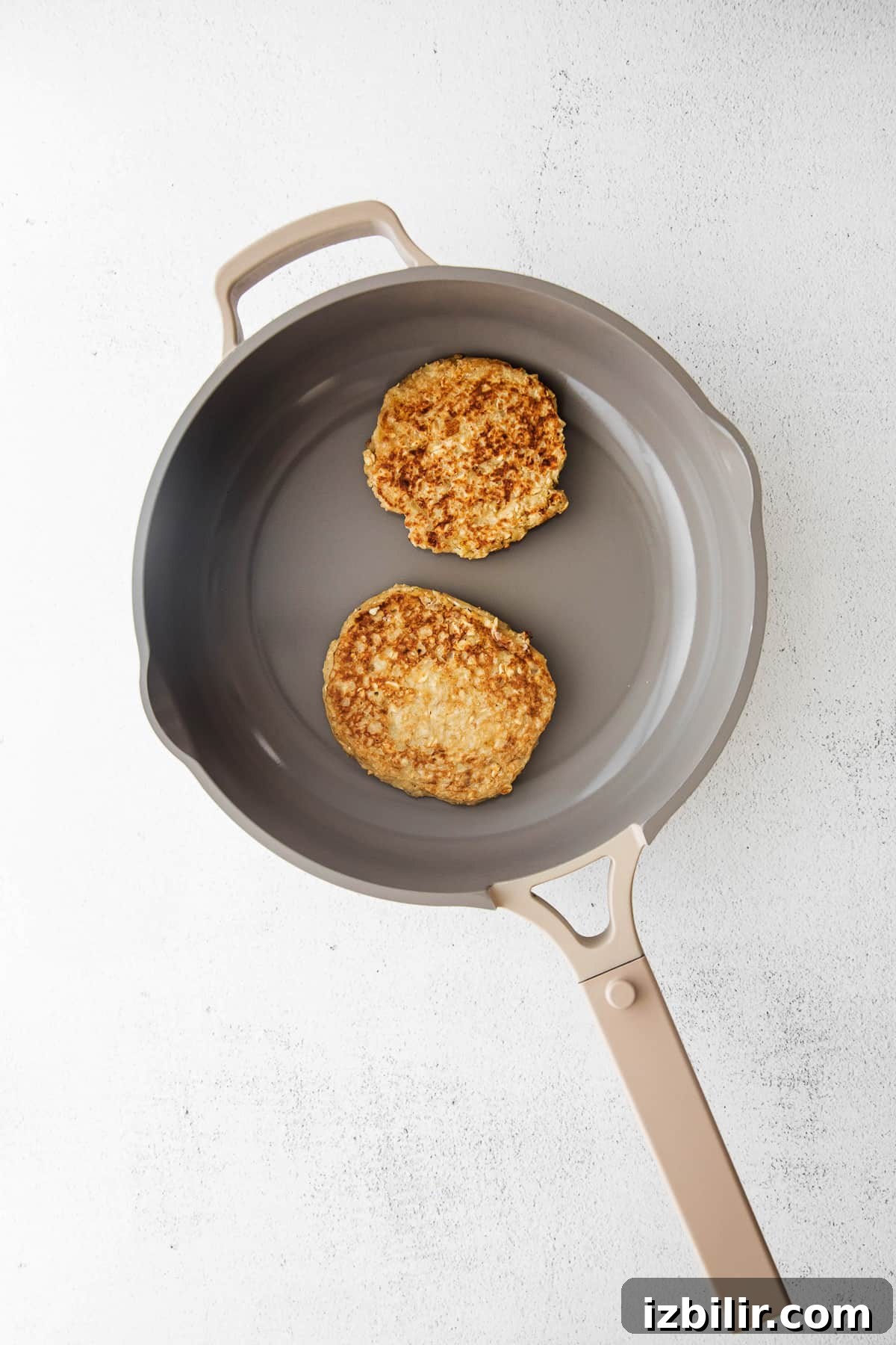 Fluffy Banana Oatmeal Pancakes Recipe 5 cooking pancakes in skillet