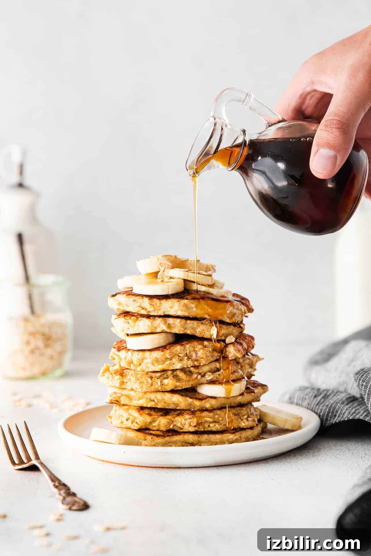 Fluffy Banana Oatmeal Pancakes Recipe 6 pouring syrup on pancakes
