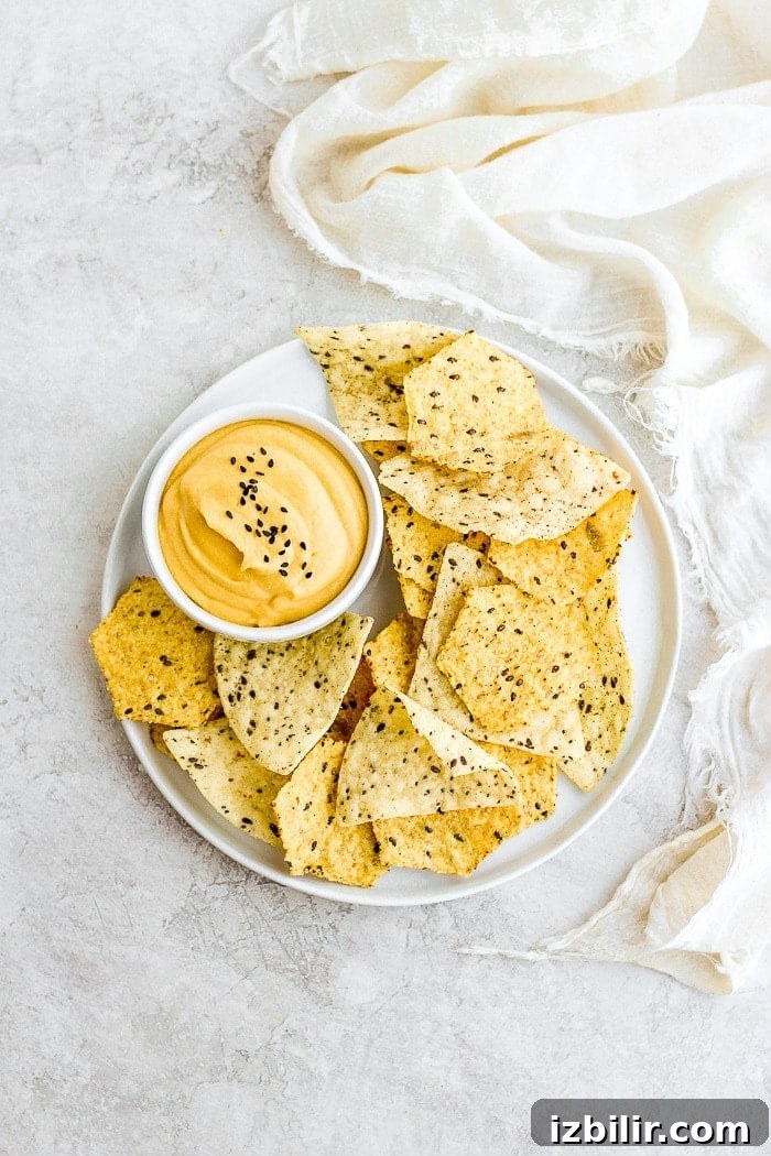 Creamy Vegan Cheese Sauce Recipe 6 Vegan Cheese Sauce on plate with chips.