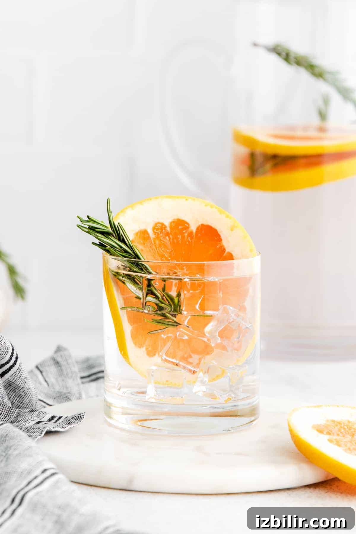 Refreshing Fruit-Infused Water Recipes to Try 8 Grapefruit and rosemary infused water in glass.