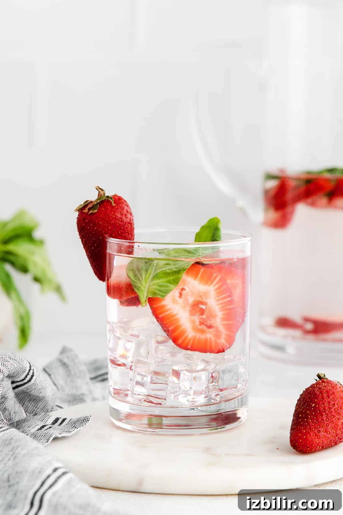Refreshing Fruit-Infused Water Recipes to Try 9 Strawberry and basil infused water in a glass.