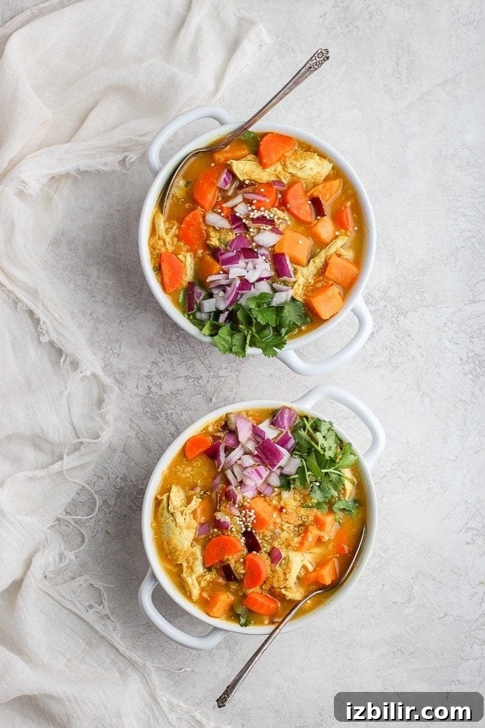 One-Pot Golden Chicken Curry Soup Recipe 6 Bowl of curry soup with lime and herbs