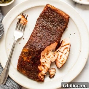 smoked salmon with fork on plate.