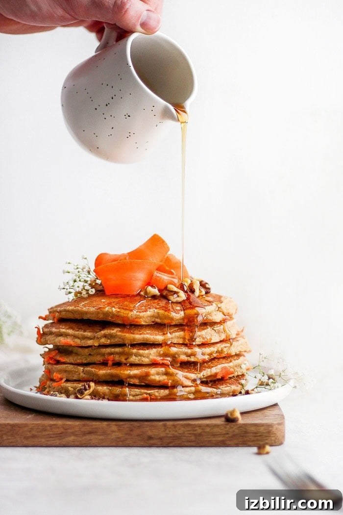 Carrot cake pancakes made with oat flour and fresh shredded carrots. healthy carrot cake pancakes on a plate