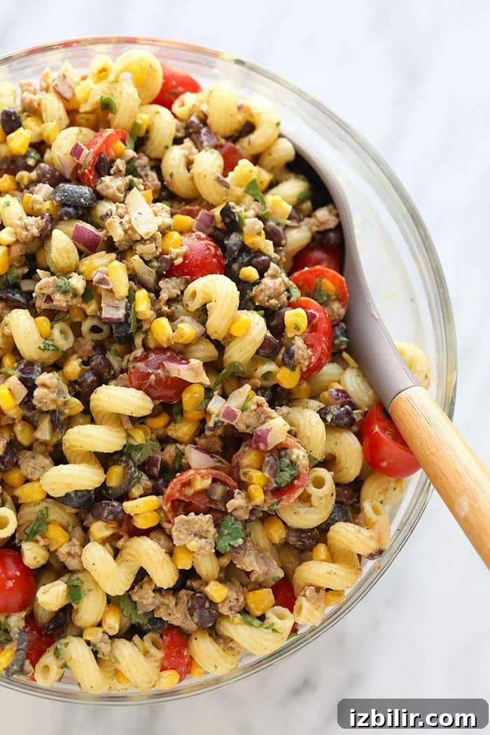 Taco Pasta Salad Recipe with Ground Beef, Cheddar and Corn 2 Taco pasta salad in large bowl.