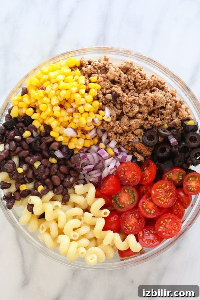 Taco Pasta Salad Recipe with Ground Beef, Cheddar and Corn 3 Taco pasta salad in glass bowl