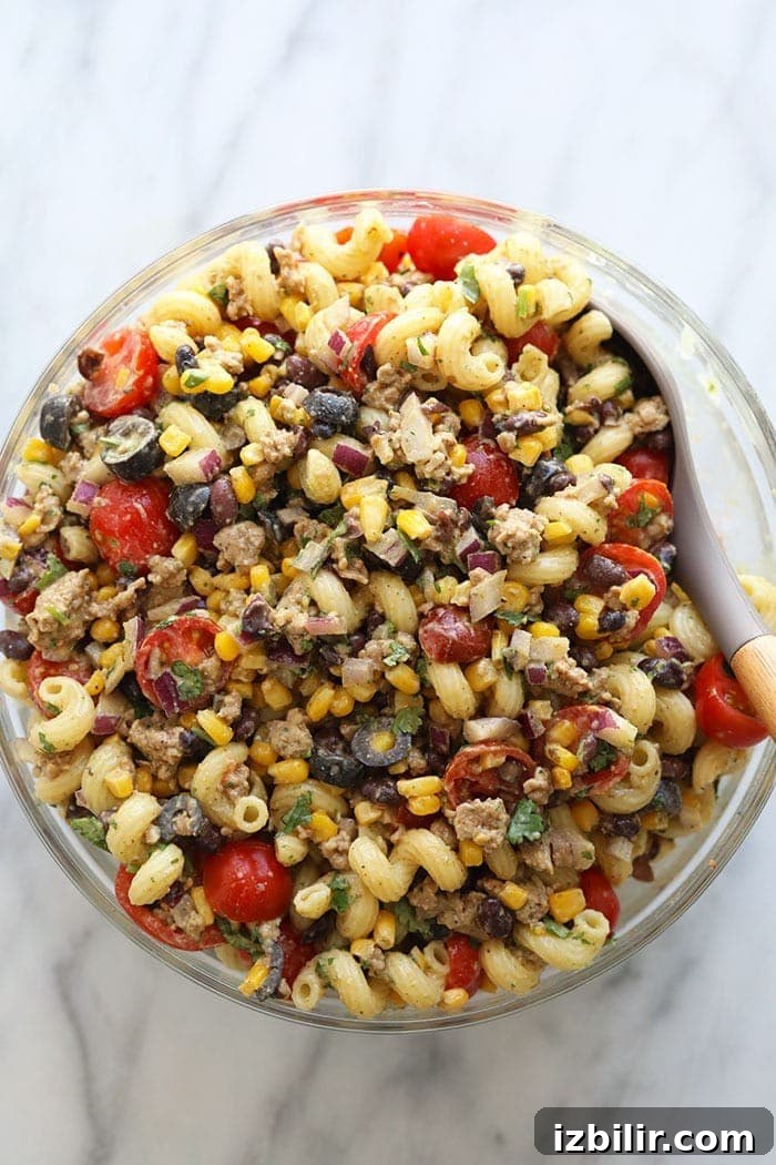 Taco Pasta Salad Recipe with Ground Beef, Cheddar and Corn 10 Healthy Taco Pasta Salad in large bowl.