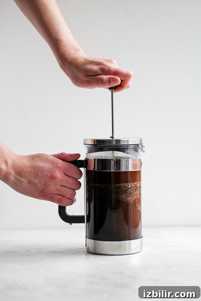 Start the day off right with the perfect cup of French press coffee! A pot of French press coffee brewing.