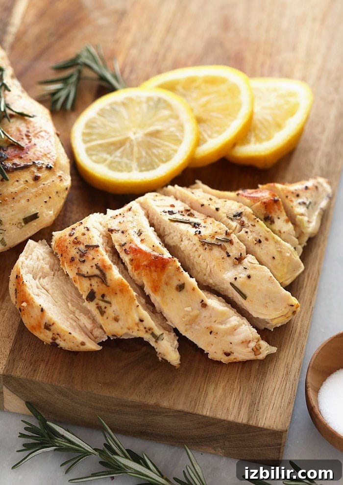 Perfectly cooked sous vide chicken breast chicken breast on a cutting board.