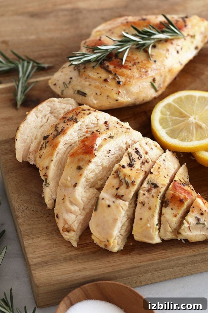 Sliced sous vide chicken breast sliced chicken breast on a cutting board.